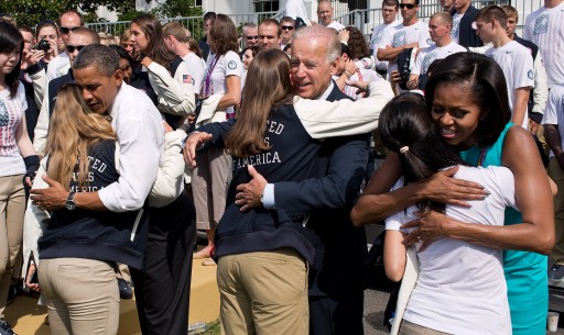 President Obama, Vice President Biden, and the First Lady hug Team USA Olympians