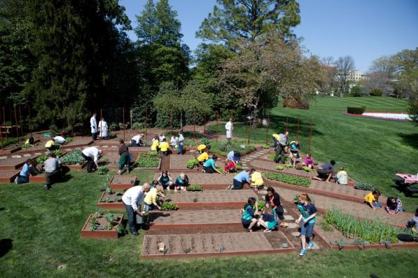First Lady Michelle Obama joins students for the spring White House Kitchen Garden planting on the South Grounds