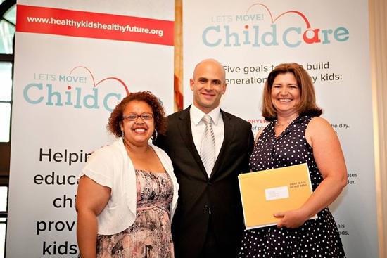 Sam Kass presents a letter of congratulations from the First Lady
