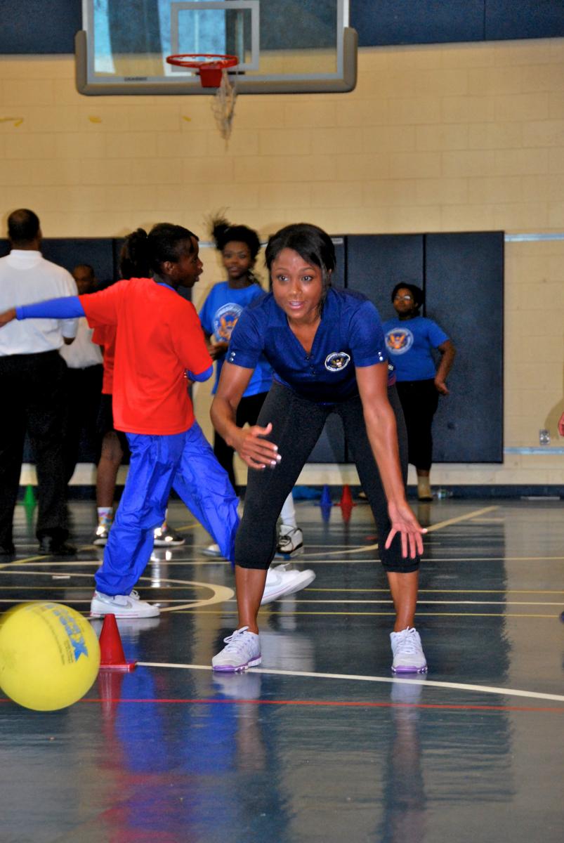 Council co-chair Dominique Dawes demonstrating her aerobic bowling skills.