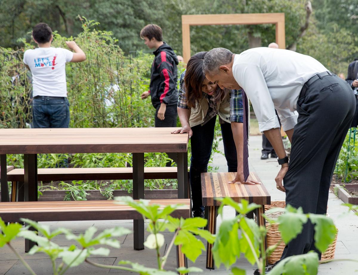 President Obama and the First Lady look at new garden benches.