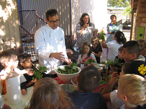 Chef John Tesar demonstrates how to make a salad with greens grown at Stonewall Jackson Elementary School’s Garden.