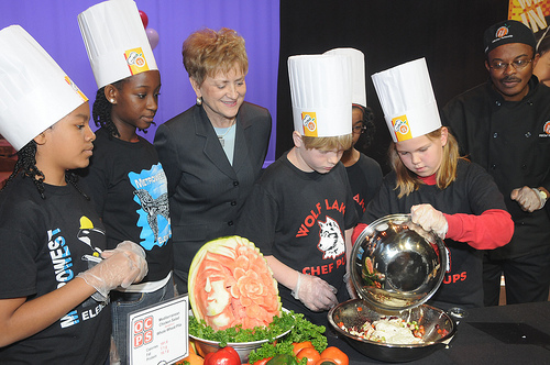 Dr. Janey Thornton, USDA Deputy Under Secretary for the Food, Nutrition and Consumer Services (center) watches as Metrowest Elementary School and Wolf Lake Elementary School student chefs cook their recipes during the Chefs Move to Schools event, Orlando, Fla. (USDA photo by Debbie Smoot)