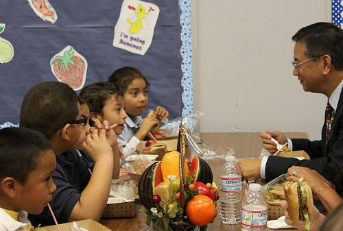 Allen Ng (right), Regional Administrator for Food and Nutrition Service, is having lunch with Columbia School students.