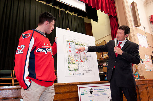 Washington Capitols Defenseman, Number: 52 Mike Green (left) and Comcast SportsNet Analyst Alan May of the The People’s Garden team for W. B. Powell Elementary School, (consisting of the Washington Capitols, U.S. Department of Agriculture and D.C. Public Schools in Washington, D.C.) revealed to 289 parents and students, the School Garden Design Concept on Thursday, March 10, 2011.  The design draft was created by Forest Service landscape architect Matt Arnn, with the support of Natural Resources Conservation Service landscape architect Bob Sneickus, Outreach and Education Coordinator Annie Ceccarini and Project Manager Leslie Burks who worked with the Principal Janeece Docal and the school during an earlier visit to develop illustrated ideas from parents and students. USDA photo by Lance Cheung.